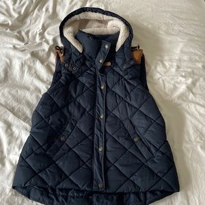 Beautiful, warm, quilted navy blue vest with brown suede trim and fleece hoodie